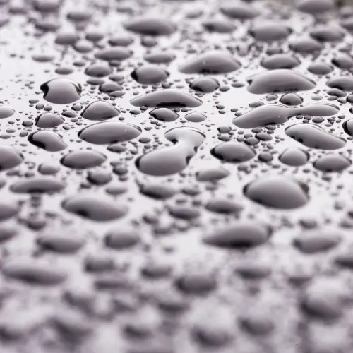 Droplets of water shown forming on a surface from condensation.