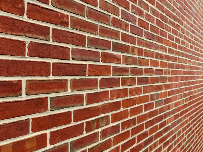 A long brick cavity wall shown with perspective.